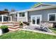 Backyard patio with stairs, a lounge chair, and a black and white rug at 6474 W Canyon Ave, Littleton, CO 80128