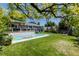 Serene backyard with a sparkling pool, deck, pergola, and lush landscaping at 6474 W Canyon Ave, Littleton, CO 80128
