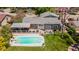 Aerial view showcasing a backyard with a pool, deck, outdoor seating, and well-maintained landscaping at 6474 W Canyon Ave, Littleton, CO 80128