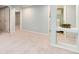Finished basement area with neutral carpeting and paint, and decoratively framed doorway at 6474 W Canyon Ave, Littleton, CO 80128
