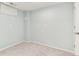 Basement room with neutral carpeting and paint, with a window and door at 6474 W Canyon Ave, Littleton, CO 80128