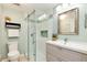 Well-lit bathroom featuring a glass shower, modern vanity, and soothing color palette, creating a spa-like experience at 6474 W Canyon Ave, Littleton, CO 80128