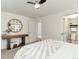 Comfortable bedroom featuring neutral decor, carpeted floors, and a view of the ensuite bathroom at 6474 W Canyon Ave, Littleton, CO 80128