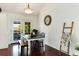 Bright dining area with French doors, hardwood floors, and stylish rustic decor at 6474 W Canyon Ave, Littleton, CO 80128