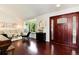 Entryway featuring a beautiful wood door, hardwood floors, and a sun-filled window seat at 6474 W Canyon Ave, Littleton, CO 80128