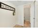 Hallway that includes a door into a powder room with tiled floors, decorative wall art, and neutral wall colors at 6474 W Canyon Ave, Littleton, CO 80128