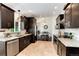 Spacious kitchen with stainless appliances, dark wood cabinetry, and stylish tile flooring at 6474 W Canyon Ave, Littleton, CO 80128