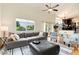 Bright and airy living room with a large sectional sofa and a large window with neighborhood views at 6474 W Canyon Ave, Littleton, CO 80128