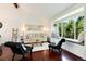 Bright living room boasts hardwood floors, vaulted ceiling, and a cozy window seat with backyard views at 6474 W Canyon Ave, Littleton, CO 80128
