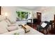 Bright living room with a large window seat, stylish furnishings, and hardwood floors at 6474 W Canyon Ave, Littleton, CO 80128