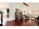 Open-concept living space featuring hardwood floors, exposed beams, and a comfortable seating area at 6474 W Canyon Ave, Littleton, CO 80128
