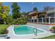 Inviting backyard pool with clear water, complemented by a spacious deck and pergola at 6474 W Canyon Ave, Littleton, CO 80128