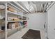 Unfinished basement space ready for storage with painted walls, exposed ceiling, and laundry area at 1818 S Quebec Way # 7-8, Denver, CO 80231