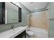 Bathroom featuring a vanity with storage space, a toilet, and shower-tub combination at 1818 S Quebec Way # 7-8, Denver, CO 80231