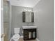 Neutral bathroom featuring a glass-enclosed shower, a toilet, and a vanity with storage space at 1818 S Quebec Way # 7-8, Denver, CO 80231