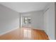 Bedroom with hardwood floors, large window, and double closet at 1818 S Quebec Way # 7-8, Denver, CO 80231