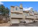 Multi-story townhome features attached garages and private balconies with neutral exterior paint at 1818 S Quebec Way # 7-8, Denver, CO 80231