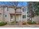 Townhome exterior with front door, gray siding, stone steps, and minimal landscaping at 1818 S Quebec Way # 7-8, Denver, CO 80231