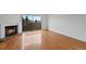 Living room featuring hardwood floors, fireplace, and sliding doors to a patio at 1818 S Quebec Way # 7-8, Denver, CO 80231