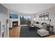Bright living room with a cozy fireplace and a sliding door to a balcony at 1818 S Quebec Way # 7-8, Denver, CO 80231
