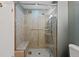 Elegant tiled shower with glass door, built-in bench, and modern fixtures at 1818 S Quebec Way # 7-8, Denver, CO 80231