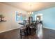 Dining room with dark wood table, four chairs, and a world map on the wall at 9021 Sandpiper Dr, Frederick, CO 80504