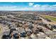 Elevated neighborhood view with houses, streets, and manicured landscaping under a partly cloudy sky at 16240 E 119Th Ave, Commerce City, CO 80022