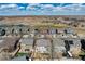 Overhead aerial view of a neighborhood featuring diverse homes, green spaces, and community pond at 16240 E 119Th Ave, Commerce City, CO 80022