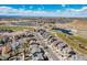 An aerial view showcasing the community, nearby park, and landscape with mountain views in the distance at 16240 E 119Th Ave, Commerce City, CO 80022