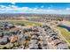 Wide aerial view of the neighborhood with sprawling green spaces and mountain views at 16240 E 119Th Ave, Commerce City, CO 80022