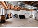 Unfinished basement space, great for storage or future customization; features exposed ductwork and support beams at 16240 E 119Th Ave, Commerce City, CO 80022