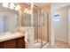 Shower stall with tile and glass enclosure; well-lit vanity area at 16240 E 119Th Ave, Commerce City, CO 80022