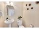 Bright powder room with a pedestal sink, modern fixtures, and decorative accents at 16240 E 119Th Ave, Commerce City, CO 80022