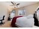 Bright bedroom with a ceiling fan, white furniture, television, and a comfortable bed with a red blanket at 16240 E 119Th Ave, Commerce City, CO 80022