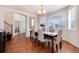 Charming dining room with hardwood floors, archways, and a large window providing natural light for Gathering meals at 16240 E 119Th Ave, Commerce City, CO 80022