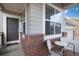 Charming front porch with seating area, brick accents, and a view of the neighborhood at 16240 E 119Th Ave, Commerce City, CO 80022