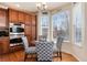 Cozy breakfast nook with seating offers natural light and views, connecting seamlessly to the well-equipped kitchen at 16240 E 119Th Ave, Commerce City, CO 80022