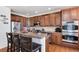 Well-appointed kitchen with stainless steel appliances, a spacious island with bar seating, and ample cabinet space at 16240 E 119Th Ave, Commerce City, CO 80022