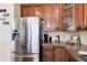 Kitchen close-up showcasing stainless steel appliances, granite countertops, and warm wood cabinetry details at 16240 E 119Th Ave, Commerce City, CO 80022