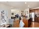 Open concept kitchen with stainless steel appliances and granite countertops overlooking the living room at 16240 E 119Th Ave, Commerce City, CO 80022