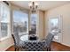 Charming breakfast nook features a round glass table, designer chairs, and a large window for enjoying morning meals at 16240 E 119Th Ave, Commerce City, CO 80022