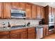 Stylish kitchen with stainless steel appliances, granite countertops, and a gas cooktop for culinary enthusiasts at 16240 E 119Th Ave, Commerce City, CO 80022