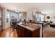 Open-concept kitchen seamlessly blends with a sunlit breakfast nook and cozy living area at 16240 E 119Th Ave, Commerce City, CO 80022