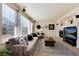 Cozy living room with a fireplace, a large sectional sofa, and modern decor at 16240 E 119Th Ave, Commerce City, CO 80022