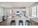 Modern kitchen with island, white cabinets and breakfast bar seating at 22042 E 38Th Pl, Aurora, CO 80019