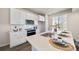 Modern kitchen with white cabinets, quartz countertops, and stainless steel appliances at 22042 E 38Th Pl, Aurora, CO 80019