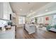 Open concept kitchen and living area with island and hardwood floors at 22042 E 38Th Pl, Aurora, CO 80019