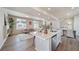 Open floor plan with kitchen island, living room and fireplace at 22042 E 38Th Pl, Aurora, CO 80019