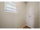 Bright laundry room with window and built-in shelving at 22042 E 38Th Pl, Aurora, CO 80019