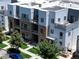 Aerial view of townhomes featuring brick facades, metal roofs and outdoor patios at 2530 Lawrence St # Ra301, Denver, CO 80205